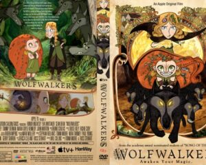 Cover art for Wolfwalkers: a girl in a red cloak and a boy in green stand in a forest among dark wolves, with the title Wolfwalkers beneath them.