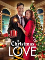 A couple in formal attire embraces by a Christmas tree, holding a sparkler and a red gift in a festive living room.