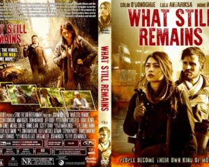 Front cover of the DVD What Still Remains: a man and woman with backpacks in a desolate, smoky landscape with the bold red title at the top.