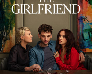 Poster for The Girlfriend: three people sit at a table with shattered glass and a red stain, against colorful mural walls; Prime Video logo visible.