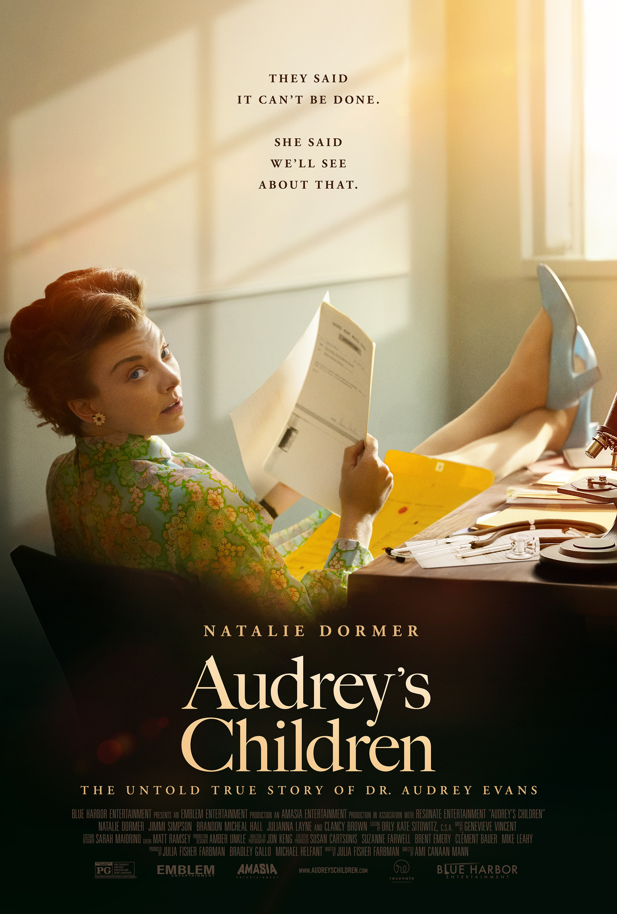 Poster for Audrey’s Children featuring a retro-looking woman reading a document at a cluttered desk bathed in warm sunlight; title and credits at bottom.