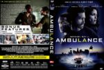 Front cover of a DVD: two men facing each other with a city skyline and police lights; bold 'AMBULANCE' title at bottom. Behind-the-scenes vibe.