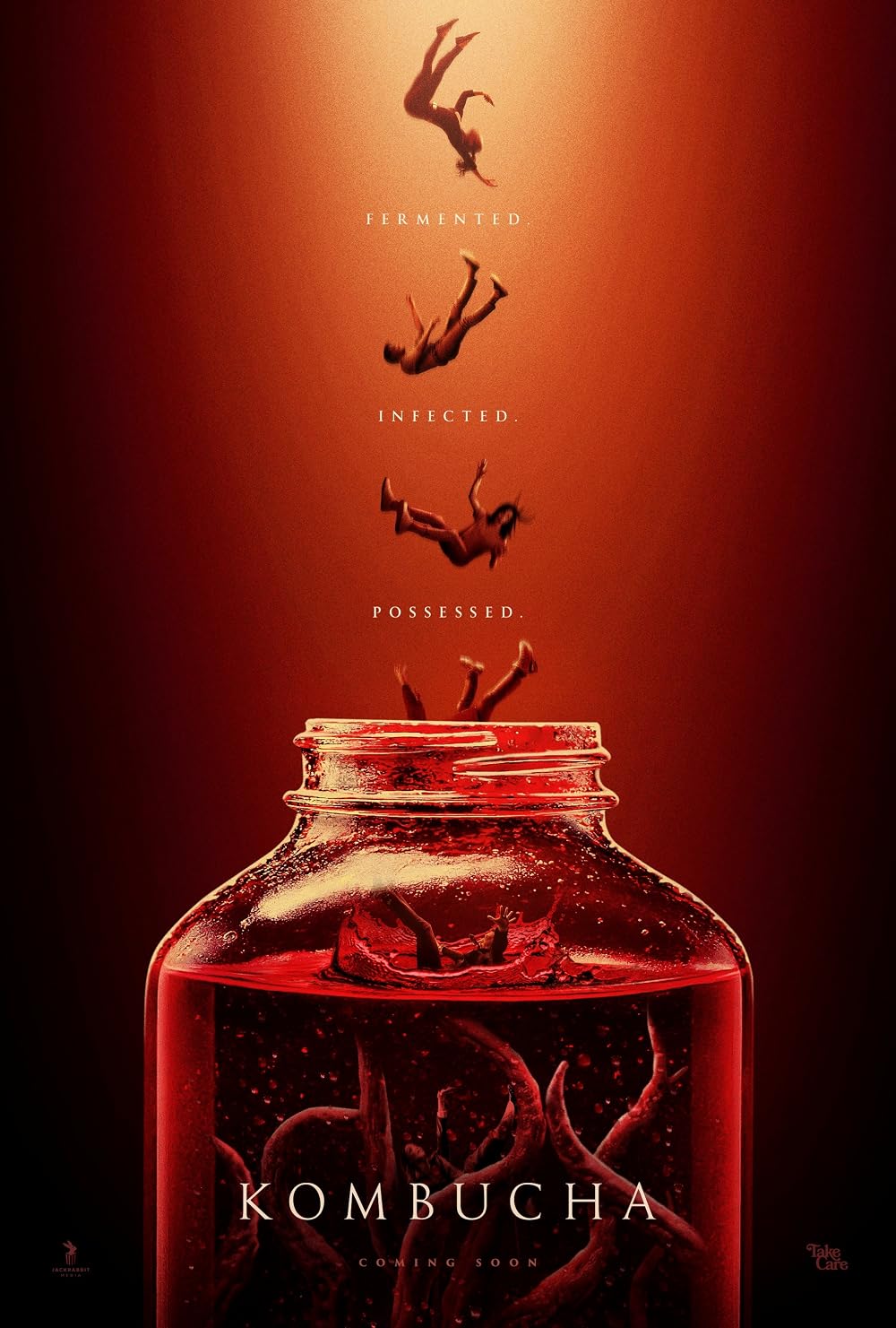 Red-tinted poster showing a large jar of red liquid with silhouettes appearing to fall into it, and the words 'Fermented', 'Infected', 'Possessed' above the jar, with 'Kombucha' at the bottom.