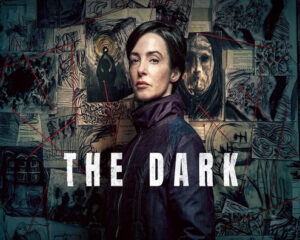 Poster of a woman in a dark coat, looking over her shoulder, against a wall of sketches and photos with the title The Dark. (Thriller/mystery vibe)